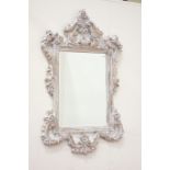 Ornate French style mirror fitted with bevelled glass,