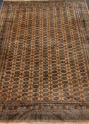 Fine quality Persian Bokhara design rug carpet, repeating guls on pale gold ground,