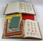 Four large albums and four books of Victorian and later used and mint world stamps,