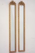 Pair narrow gilt framed wall mirrors with ornate pediments and bevelled glass Condition