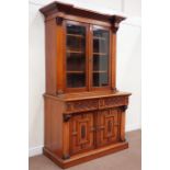 Victorian walnut bookcase on cupboard enclosed by two glazed doors raised upon panelled cupboards