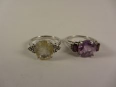 Amethyst and garnet set ring and a rutilite set ring both stamped 925 Condition Report
