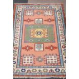Turkish carpet central medallion with guls over pink ground further panels geometric boarders,