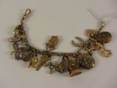Victorian/Edwardian yellow gold and platinum link watch chain bracelet with seventeen charms -