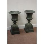 Pair copper finish cast iron garden urns on plinths, D36cm,