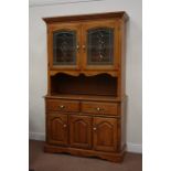 Light oak wall display cabinet enclosed by two glazed doors, above two drawers and two cupboards,
