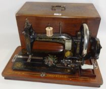 Early 20th century Naumann Sewing Machine in walnut case Condition Report <a