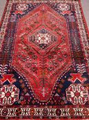 Persian Shiraz hand knotted blue ground rug, horse motifs, elongated lozenge,