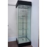 Glazed illuminated shop display cabinet, enclosed by single door,