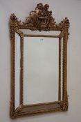 Large gilt wood and gesso mirror, decorated with ornate floral mouldings,