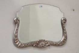 Silvered shell moulded framed mirror with bevelled glass,