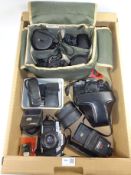 Olympus OM20 and OM10 SLR cameras and a Minolta X-300 SLR camera and accessories