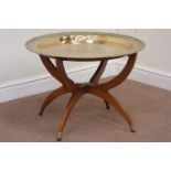 Circular engraved brass top table raised on folding teak base,