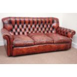 Three seat traditional sofa upholstered in deeply buttoned vintage red leather,