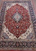 Fine quality Persian Nain deep red, blue and beige ground rug, overall floral decoration,