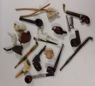 A collection of clay, ceramic and carved wooden pipes,