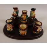 A collection of six miniature Royal Doulton Toby jugs on stand Condition Report