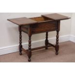 Mid 20th century medium oak work table with sliding top, raised on bobbin turned stretcher base,