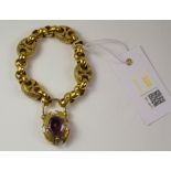 Victorian gold scroll link bracelet with amethyst set locket tested to 9ct approx. 38.