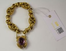 Victorian gold scroll link bracelet with amethyst set locket tested to 9ct approx. 38.