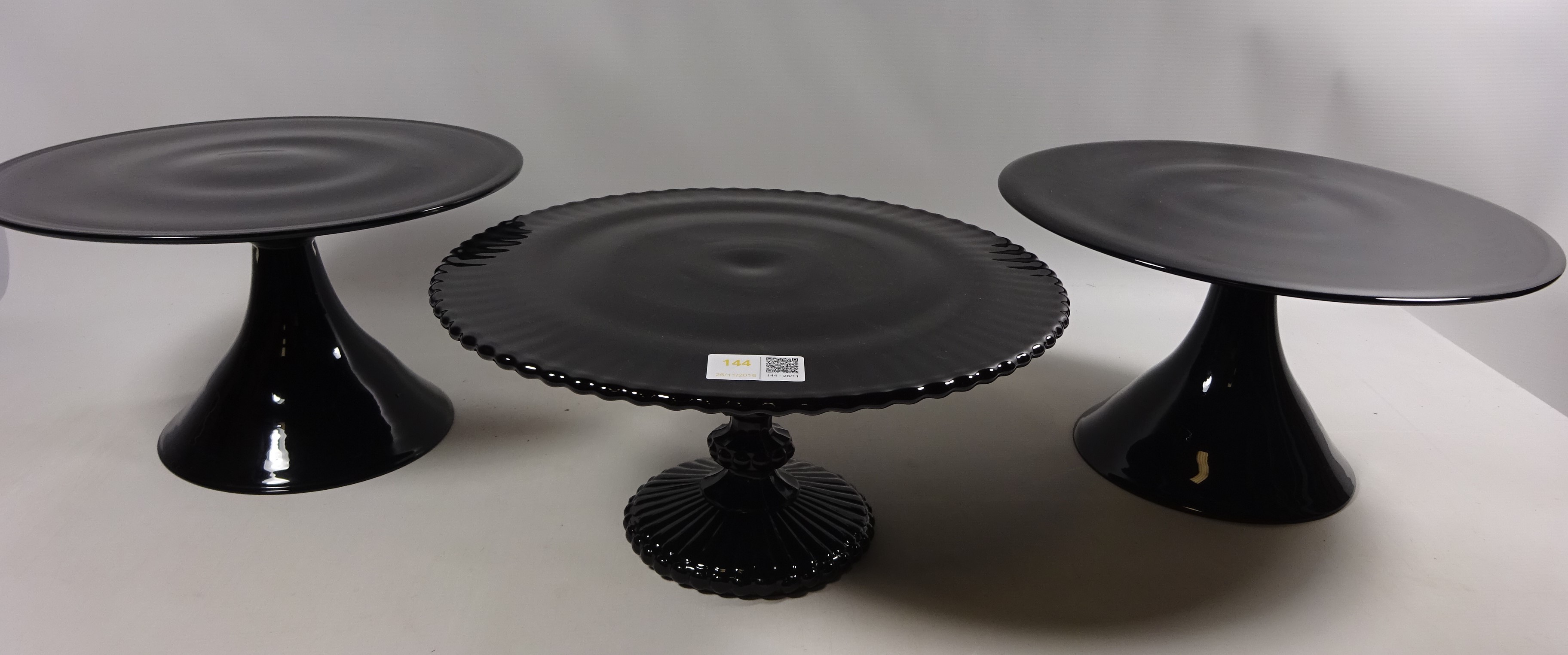 Pair of contemporary black glass pedestal cake stands and one other Condition Report