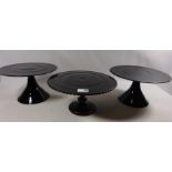 Pair of contemporary black glass pedestal cake stands and one other Condition Report