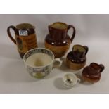 Royal Doulton salt glazed jug, 'For Every Ill' , three Doulton Lambeth graduating jugs,