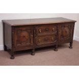 Early 20th century oak sideboard fitted with two panelled cupboards with two central drawers,