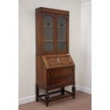 Early 20th century oak bureau bookcase enclosed by two lead glazed doors above fall front and two