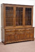 Medium oak three drawer wall display cabinet enclosed by three lead glazed doors,