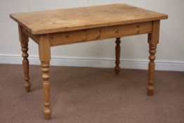 Rectangular pine dining table raised on turned base, 122cm x 76cm,