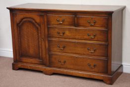 Quality reproduction oak dresser base fitted with single cupboard, two short and three long drawers,