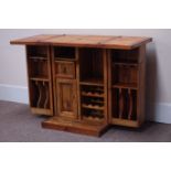 Pine bar cabinet, foldover top, fitted with double cupboard, enclosing wine and drink holders,