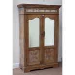 Indian teak cupboard enclosed by carved panelled and bevel mirror glazed doors, with tiled frieze,