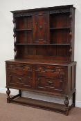 Early 20th century oak dresser fitted with two cupboards and two drawers with raised cupboard and