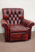 Armchair upholstered in deeply buttoned vintage red leather,