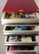 Vintage four drawer cabinet containing sewing accessories, buttons,