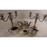 Three piece silver plated tea set and a pair of silver plated candelabra's and a small jug