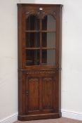 Reproduction oak corner display cabinet, above cupboard enclosed by linenfold door, W71cm,