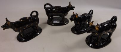 Four Jackfield type cow creamers with gilt decoration Condition Report <a