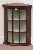 Reproduction mahogany bow front wall hanging corner cabinet enclosed by astragal glazed door,