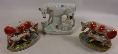 Staffordshire model of a milk maid with cow and a pair of Staffordshire type cow groups (3)