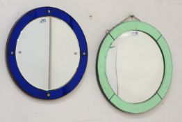 Early 20th century convex wall mirror surrounded by green tinted glass and another wall mirror with