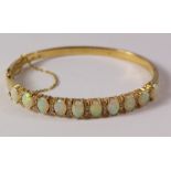 Gallery set opal and diamond hinged bangle comrising ten opals and twenty - seven diamonds stamped