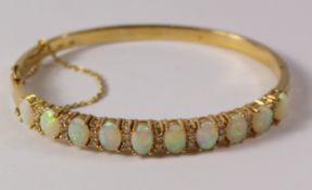 Gallery set opal and diamond hinged bangle comrising ten opals and twenty - seven diamonds stamped