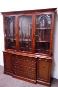 Reproduction mahogany breakfront bookcase, on sideboard fitted with two cupboards and four drawers,