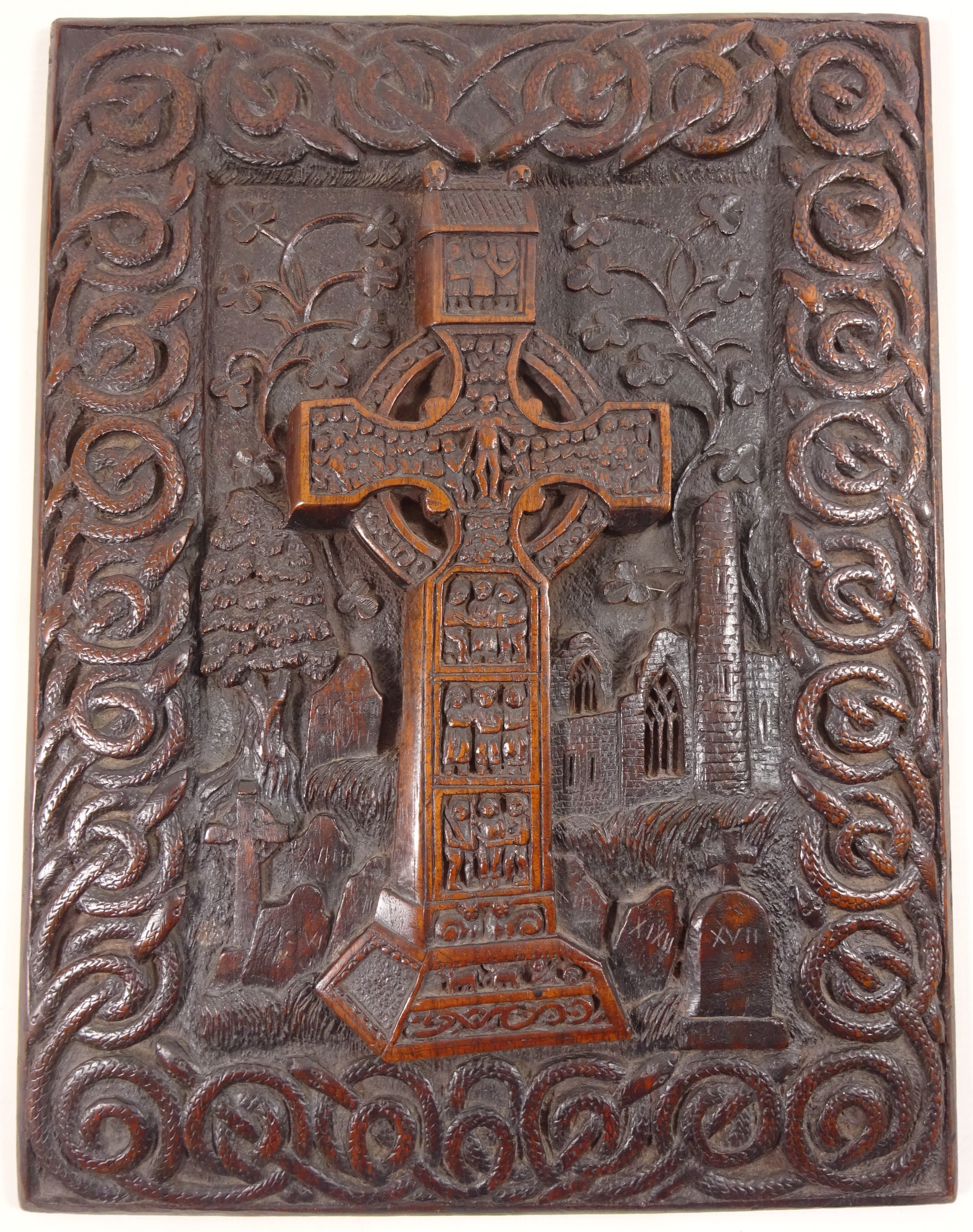 Late 19th century Irish oak panel relief carved with the round tower at Monasterboice and the