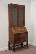 Early 20th century oak bureau bookcase enclosed by two lead glazed doors above fall front and two