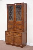 Jaycee medium oak wall cabinet enclosed by two lead glazed doors, above cupboard, W95cm, H126cm,