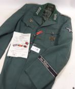 German SS jacket with Iron cross, medal ribbons, named on inside pocket and with related paperwork ,